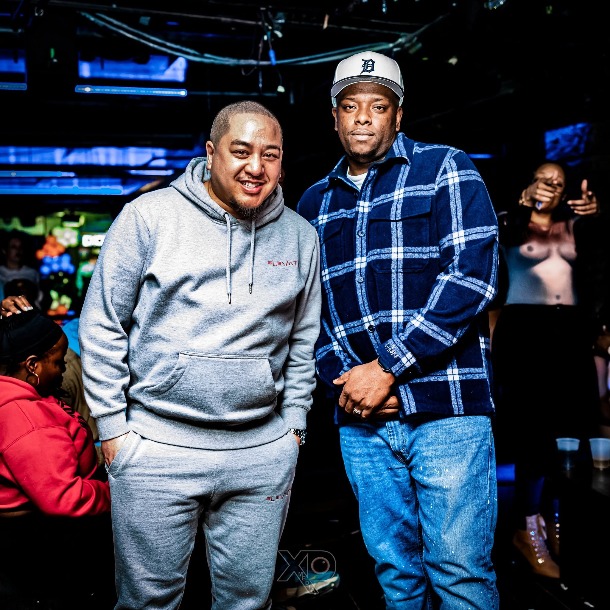 Two men posing at a nightclub event