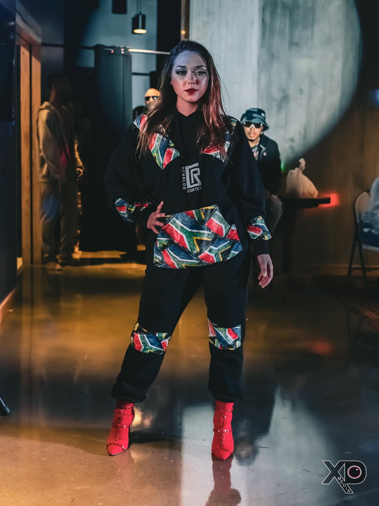 Woman in Renaldo Cortez patterned hoodie on runway