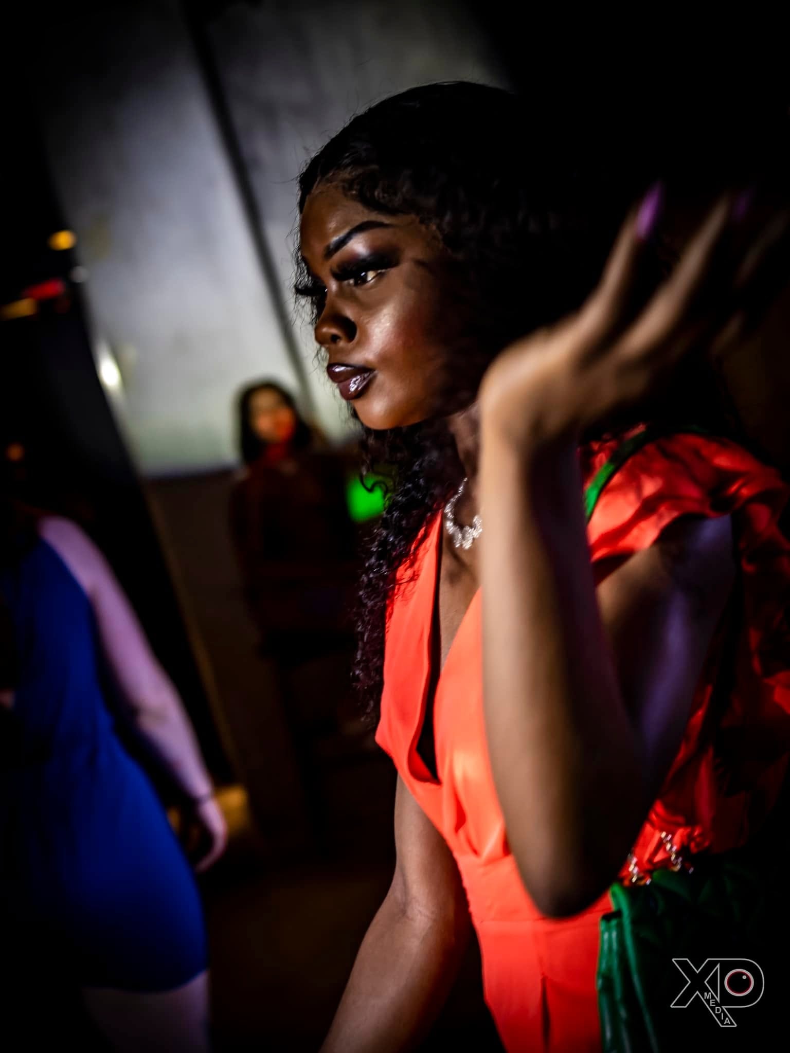 Woman in red outfit at nightclub event