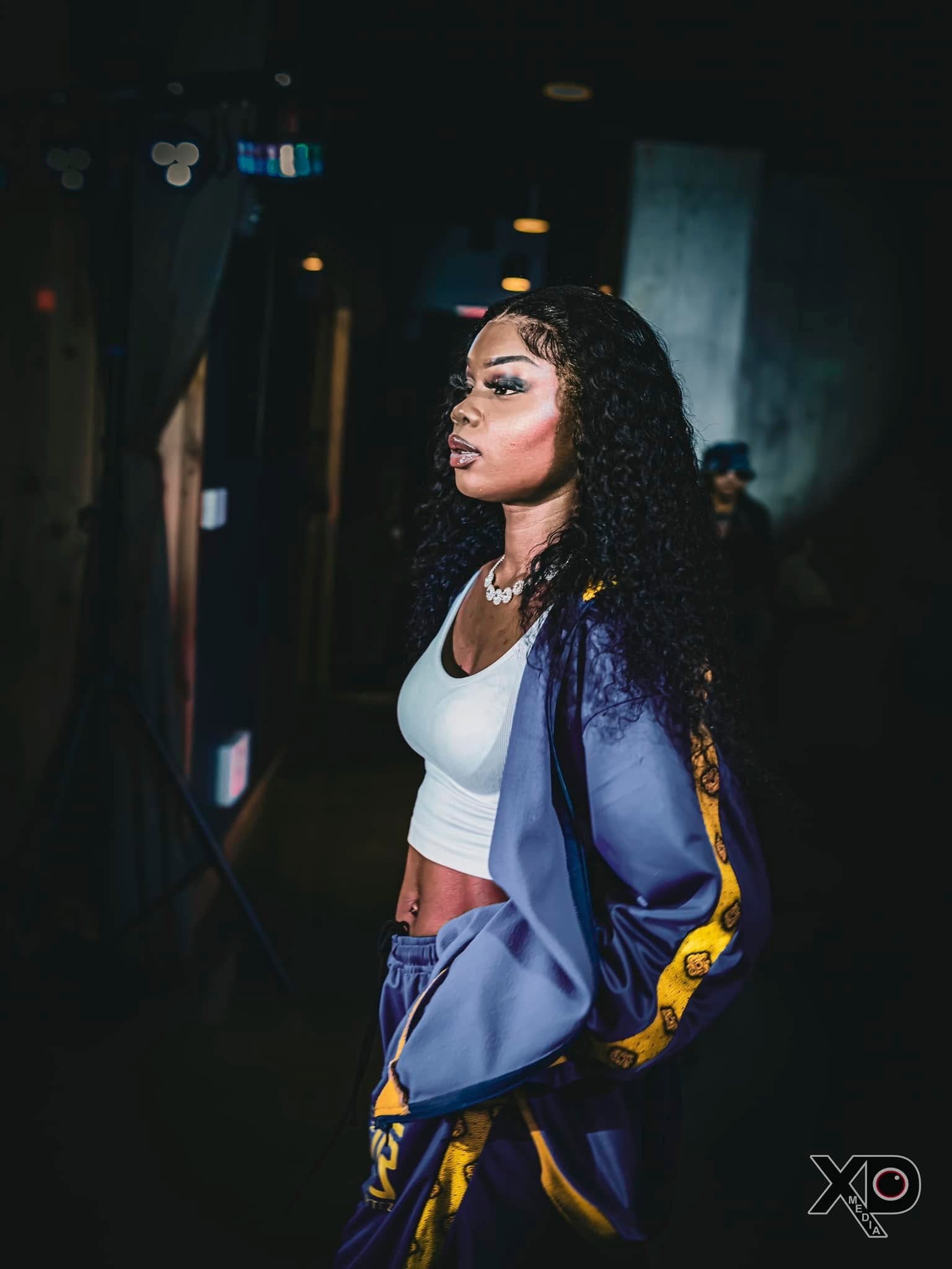 Woman in purple and gold tracksuit portrait