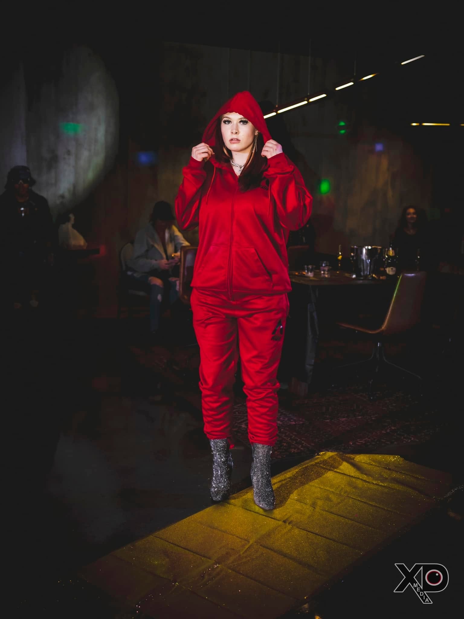 Woman in red hoodie tracksuit on runway