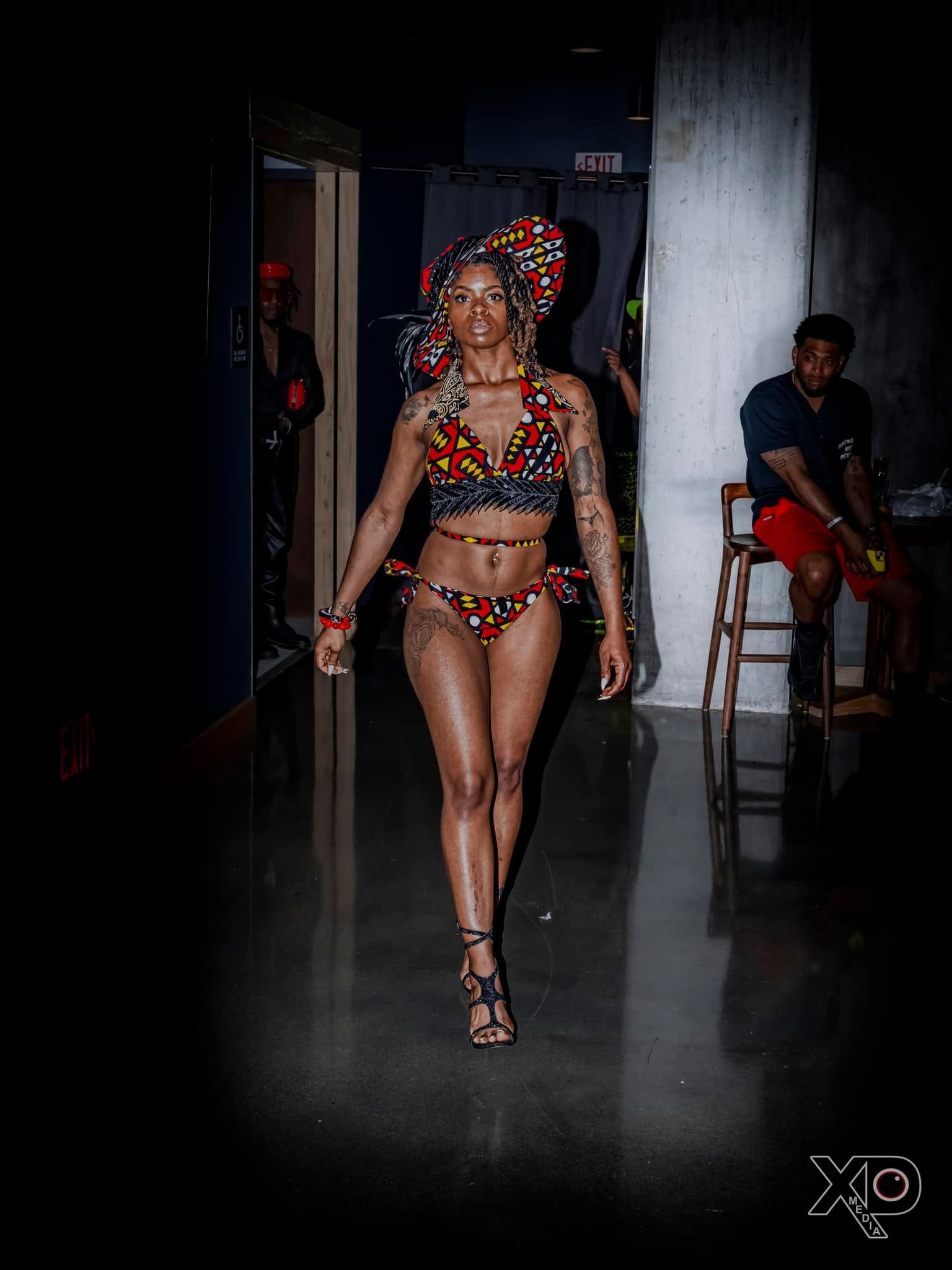 Woman in African print bikini walking runway
