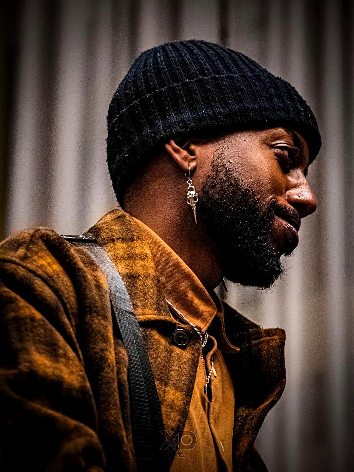 Man model in black beanie and mustard jacket portrait