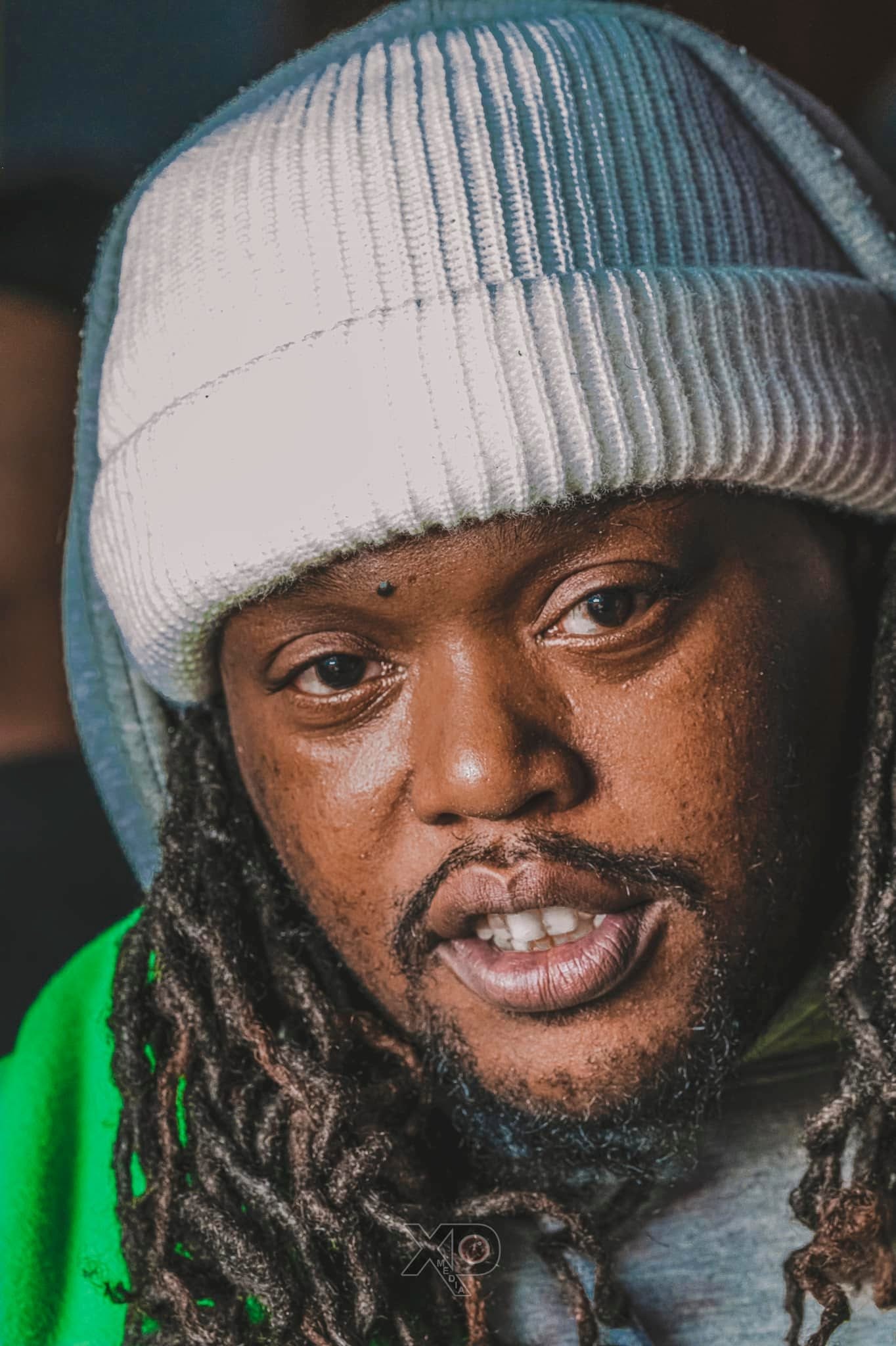 Close up portrait with locs and beanie